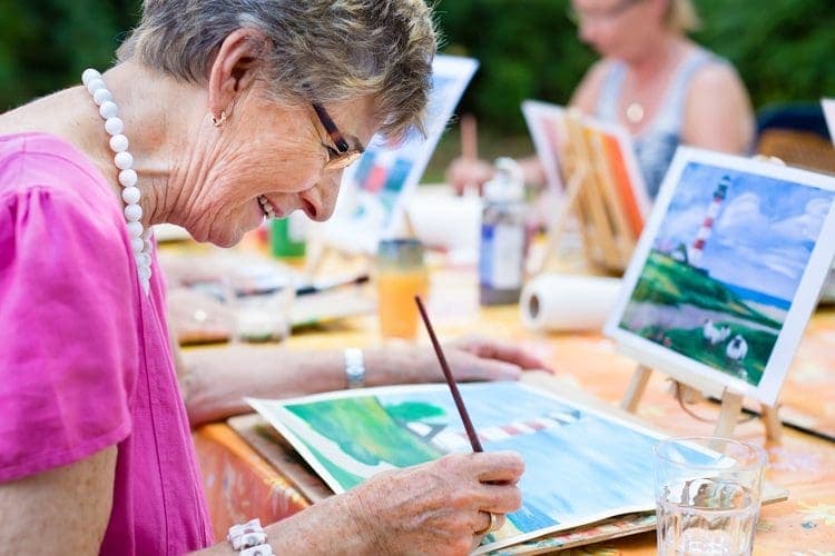 Seniors enjoying a painting activity together